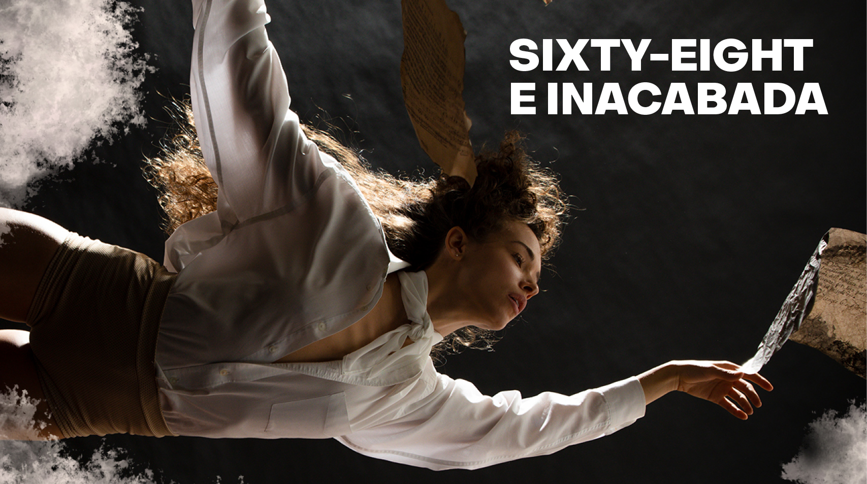 Foto de bailarina branca que flutua suspensa no ar vestindo uma camisa branca e escrito em preto Sixty eight e inacabada